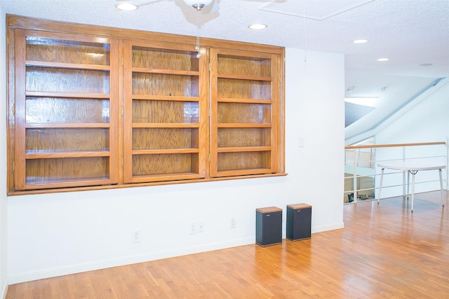 8235 Sands Point Dr Unit 156, Houston, TX 77036 - empty room with attic access, wood finished floors, a textured ceiling, and recessed lighting