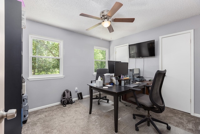 carpeted office with ceiling fan and a textured ceiling