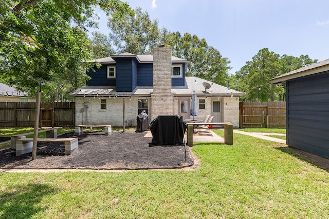 back of house featuring a patio and a lawn