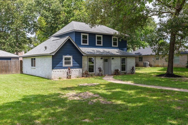 view of front facade featuring central AC and a front yard