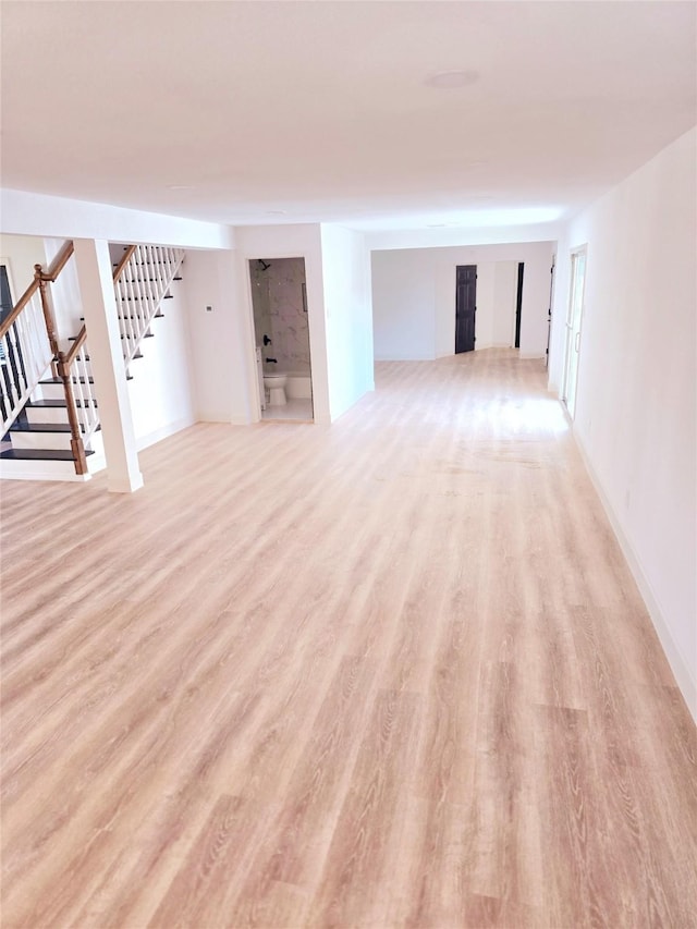 basement with light hardwood / wood-style flooring