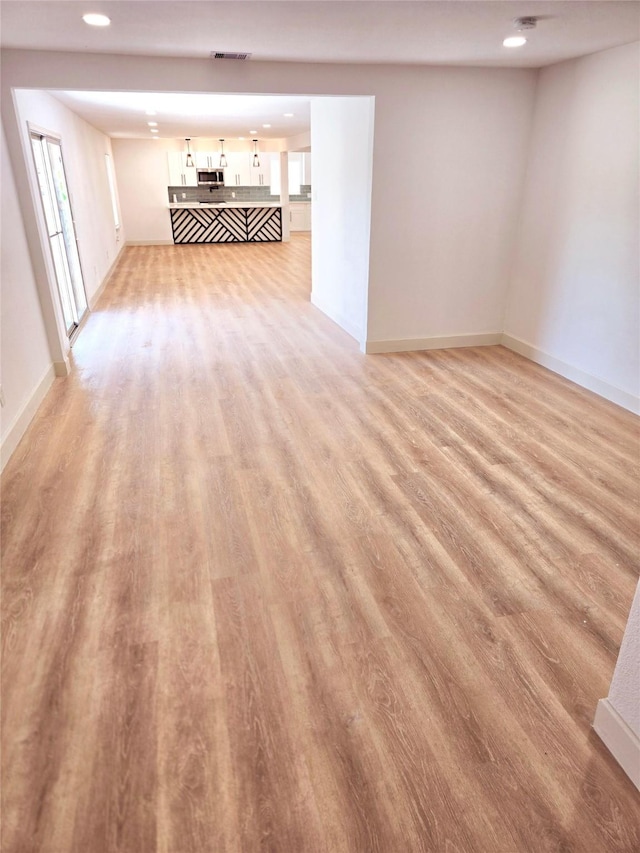 unfurnished living room featuring light wood-type flooring