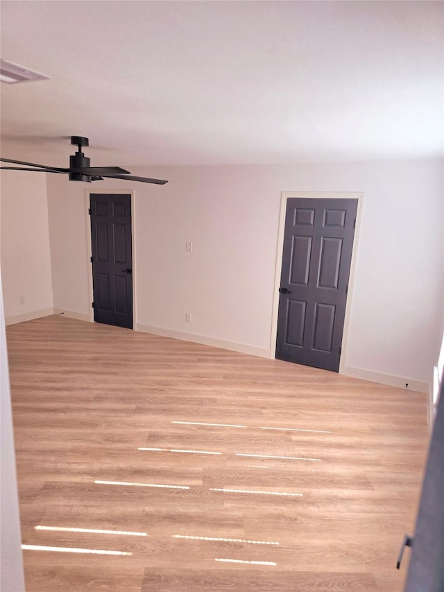 spare room with ceiling fan and light hardwood / wood-style floors