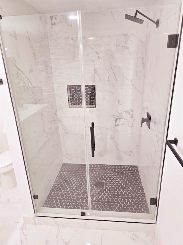 bathroom with an enclosed shower and toilet