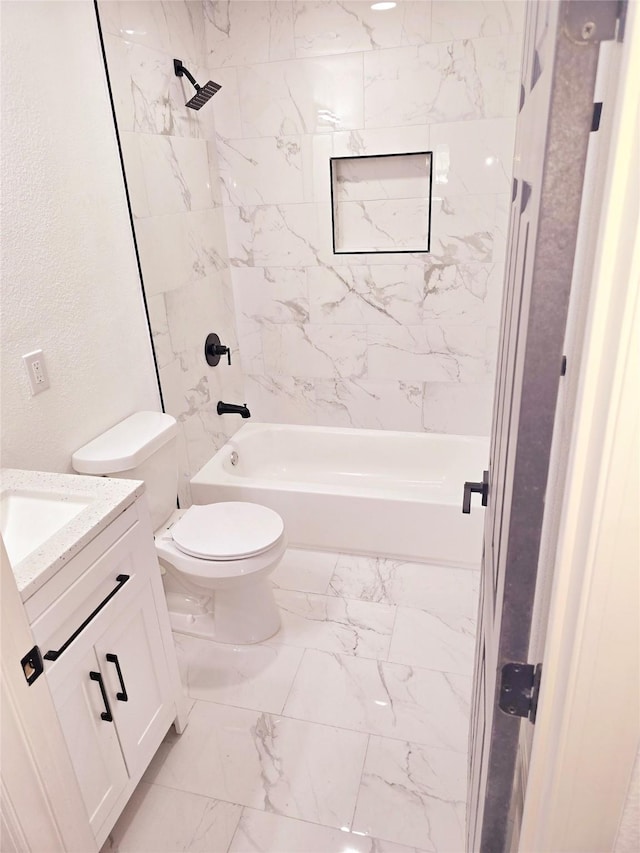 full bathroom with toilet, vanity, and tiled shower / bath