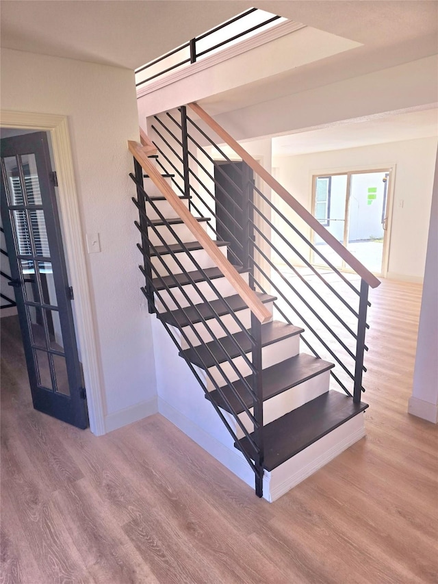 staircase featuring wood-type flooring