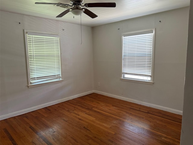 empty room featuring baseboards, a ceiling fan, and hardwood / wood-style flooring