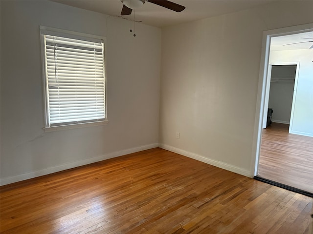 unfurnished room featuring ceiling fan and light wood-type flooring