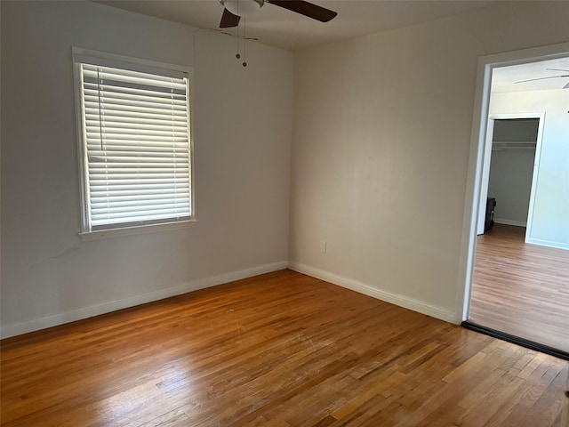 unfurnished bedroom with baseboards, a ceiling fan, and wood finished floors
