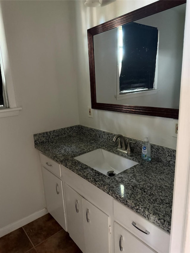 bathroom with tile patterned floors, baseboards, and vanity