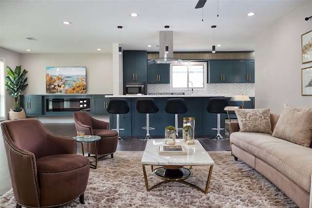 living room featuring wood-type flooring and ceiling fan