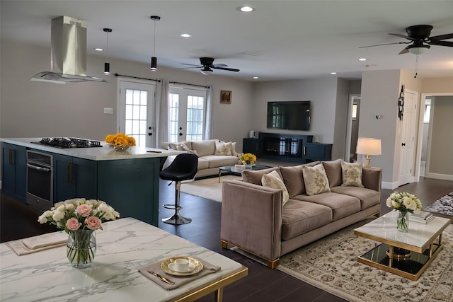 living room with french doors, dark hardwood / wood-style floors, and ceiling fan