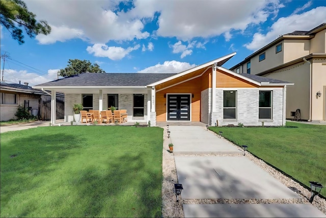 view of front of home with a patio area and a front yard