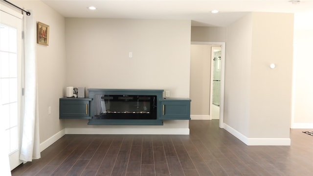 unfurnished living room with dark wood-type flooring