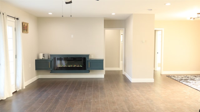 unfurnished living room featuring dark hardwood / wood-style flooring