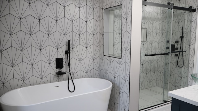 bathroom featuring vanity, tile walls, and independent shower and bath