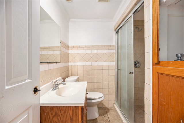 bathroom featuring tile walls, a shower with shower door, vanity, toilet, and tile patterned floors