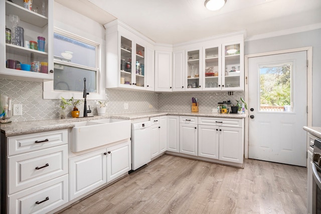 kitchen with backsplash, light hardwood / wood-style floors, dishwasher, and white cabinets