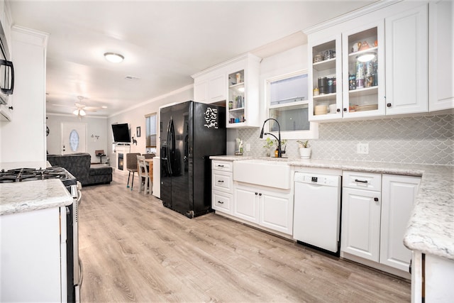 kitchen with white cabinetry, light hardwood / wood-style flooring, decorative backsplash, white appliances, and ceiling fan