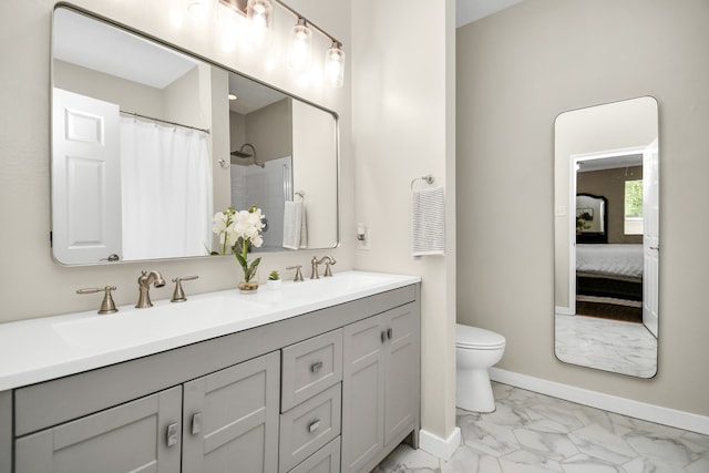 bathroom with toilet, vanity, and a shower with shower curtain