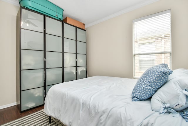 bedroom featuring crown molding, a closet, and dark wood-type flooring