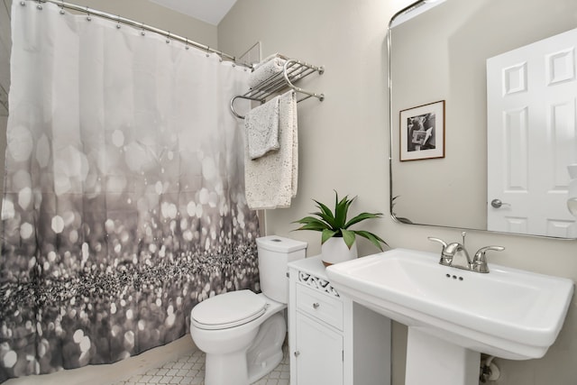 bathroom with tile patterned floors, toilet, and sink