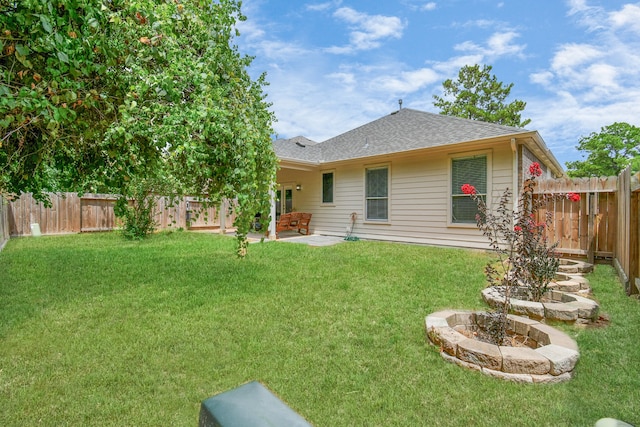 back of house with a patio area and a yard