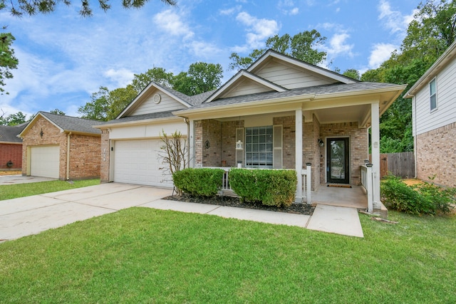 view of front of home with covered porch, a garage, and a front lawn