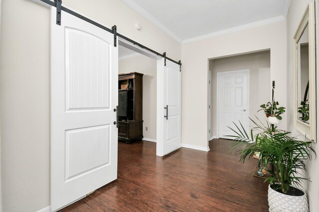 hall featuring a barn door, ornamental molding, and dark wood-type flooring