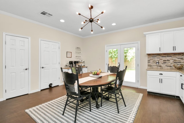 dining area featuring french doors, dark hardwood / wood-style flooring, an inviting chandelier, and ornamental molding