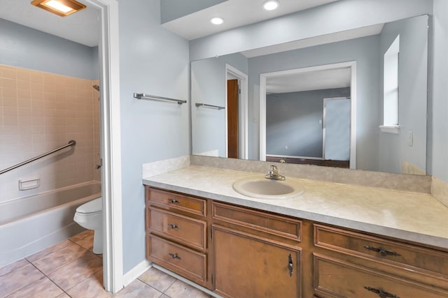 full bathroom featuring vanity, tiled shower / bath combo, toilet, and tile patterned flooring