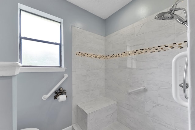 bathroom with tiled shower