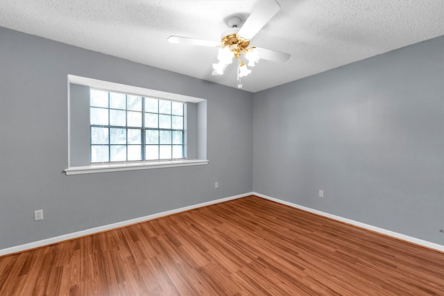 spare room with ceiling fan, hardwood / wood-style floors, and a textured ceiling