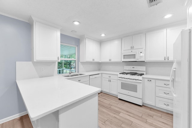 kitchen with white cabinets, light hardwood / wood-style flooring, sink, and white appliances