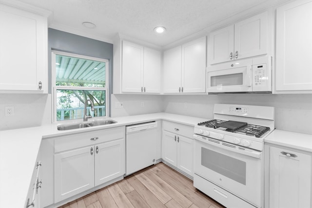 kitchen featuring light hardwood / wood-style floors, white cabinetry, white appliances, a textured ceiling, and sink