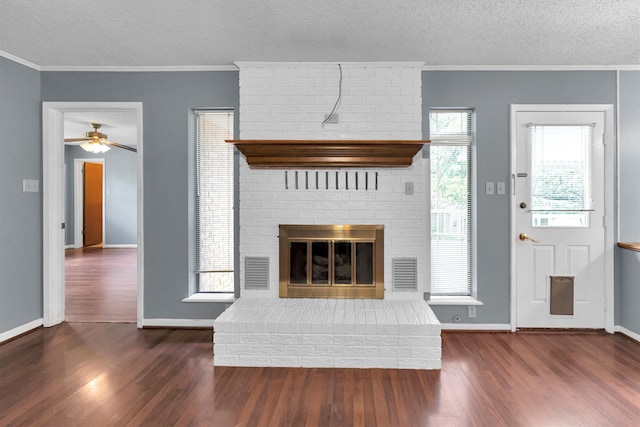 unfurnished living room featuring a fireplace, dark hardwood / wood-style floors, and a wealth of natural light