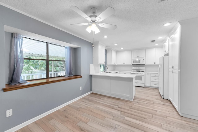 kitchen with white cabinetry, white appliances, kitchen peninsula, ceiling fan, and light hardwood / wood-style flooring