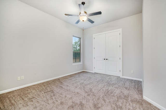 unfurnished bedroom with light carpet, ceiling fan, and a closet