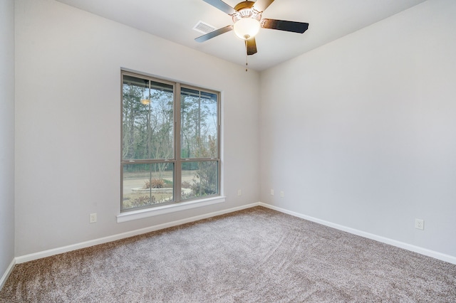 carpeted empty room featuring a healthy amount of sunlight and ceiling fan