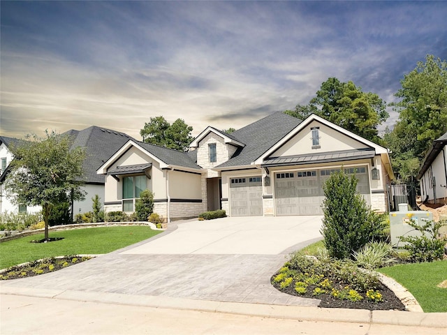 view of front of house featuring a garage and a front lawn