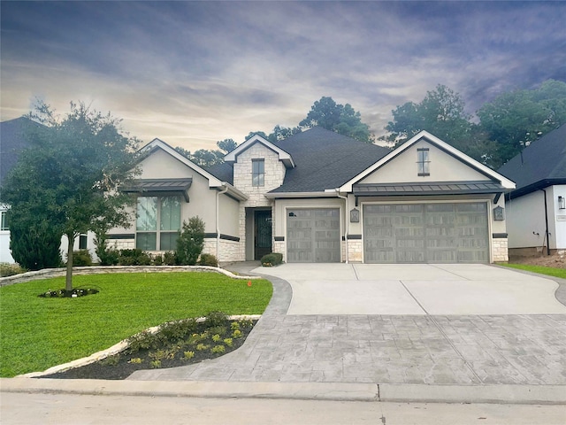 view of front of home with a front yard and a garage