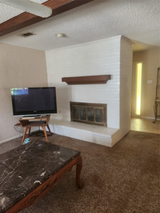 carpeted living room featuring a large fireplace and a textured ceiling