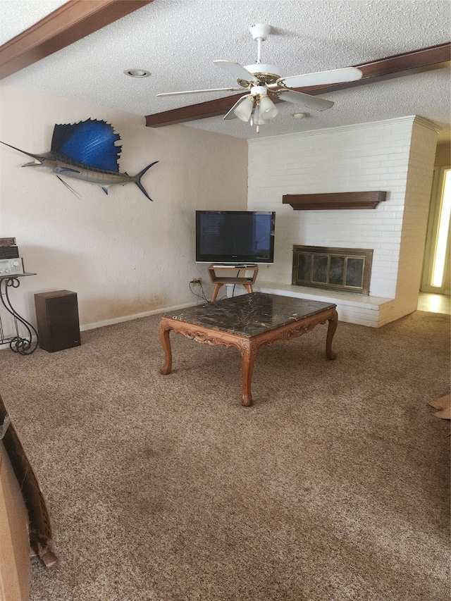 living room featuring carpet, a brick fireplace, ceiling fan, a textured ceiling, and beam ceiling