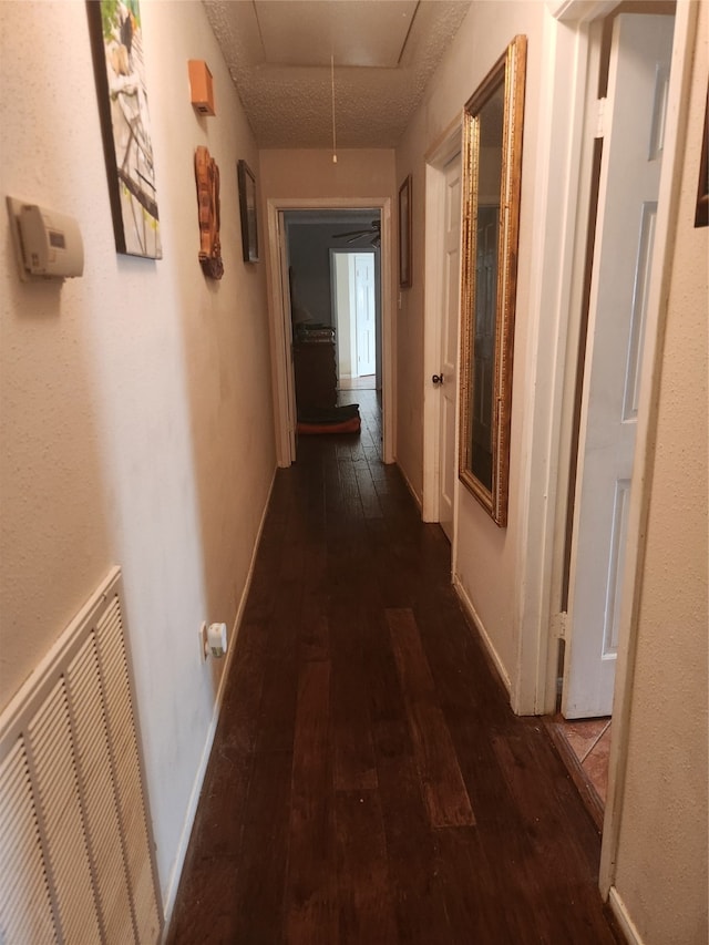 corridor with dark hardwood / wood-style flooring