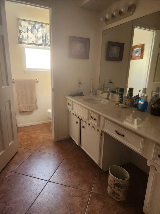 bathroom featuring tile patterned flooring, vanity, and toilet