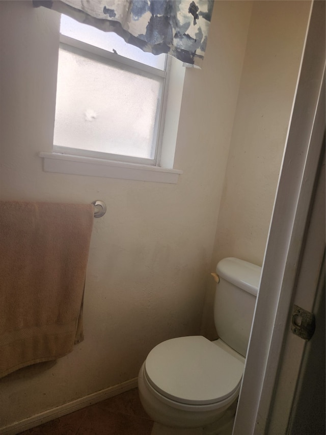 bathroom featuring tile patterned flooring and toilet