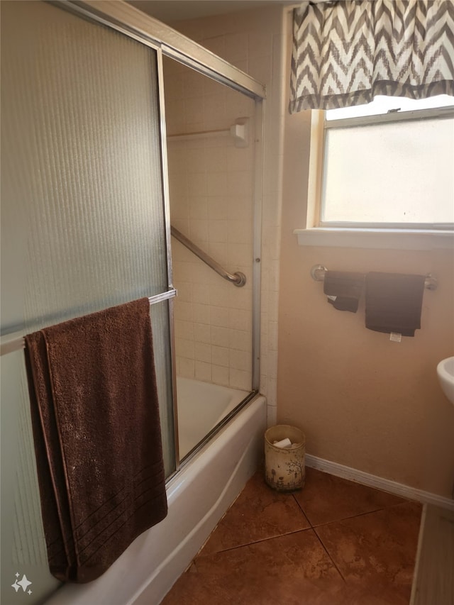 bathroom featuring tile patterned floors and bath / shower combo with glass door