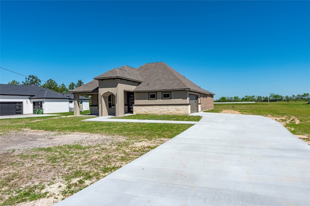 view of front of property with a front lawn and a garage