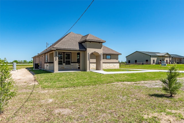 back of house with a yard, central AC, and a patio area