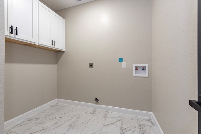 clothes washing area with cabinets, hookup for an electric dryer, and washer hookup